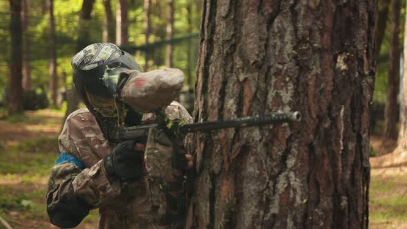 Participating in a Leisure Activity Playing Paintball with Friends Wearing Camouflage Masks