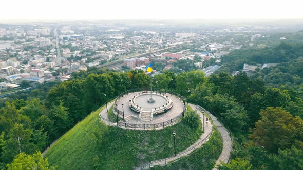 Aerial View Woman Running on Top of a Mountain in the Park