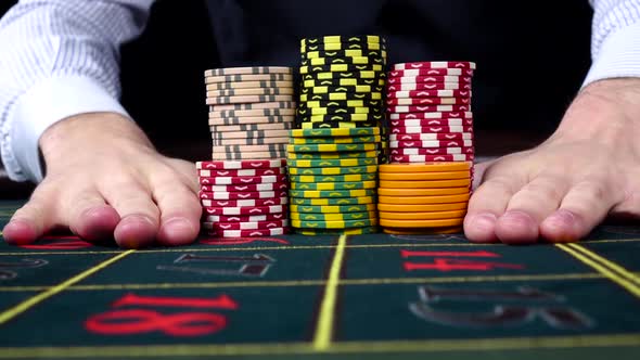 Croupier Moves Chips on Table at Casino, Black, Front View