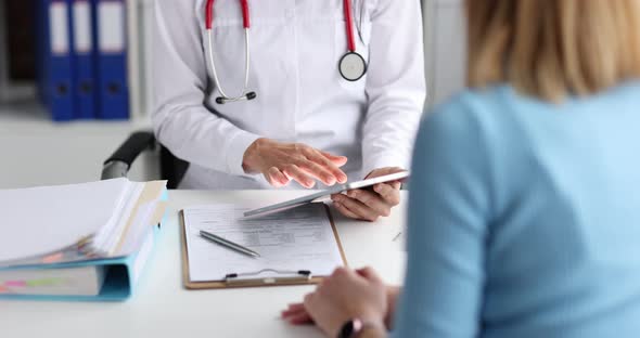 Doctor Listens to Patient and Takes Notes on Tablet