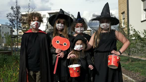 Group Portrait of Children in Black Fancy Dress. Everyone Has Medical Masks on Their Faces