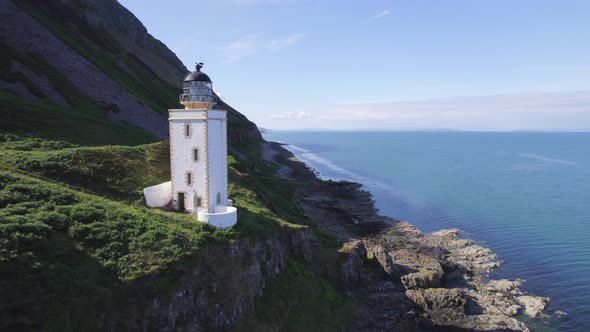 A Beautiful Square Lighthouse on a Cliff in the Summer