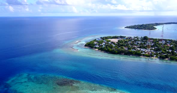 Luxury fly over travel shot of a sunshine white sandy paradise beach and aqua turquoise water backgr