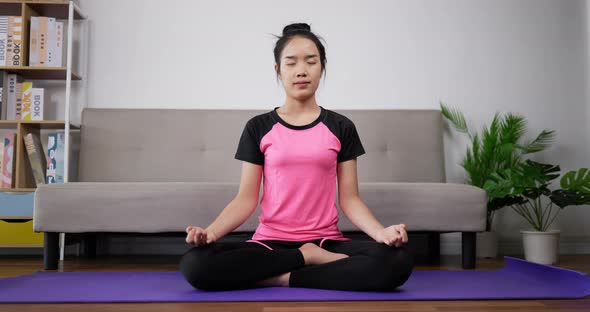 Woman meditating in lotus position sitting