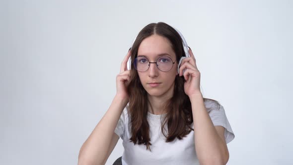 Nerd Girl Listens to Music on Headphones