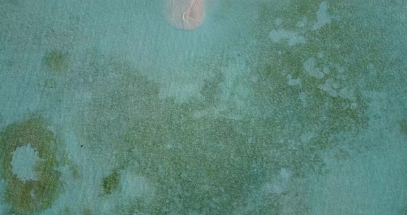 Wide angle drone island view of a sandy white paradise beach and aqua turquoise water background 