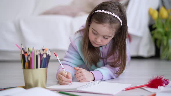 Girl Doing Homework on Floor