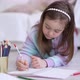 Girl Doing Homework on Floor - VideoHive Item for Sale