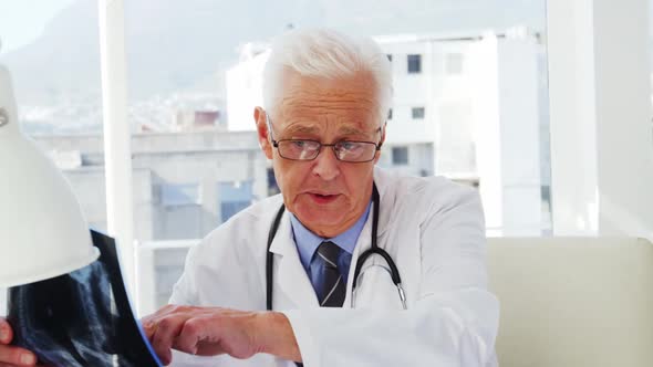 Male doctor examining x-ray