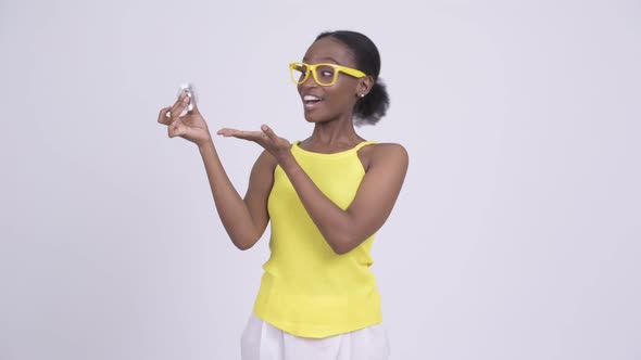 Young Happy African Woman Playing with Fidget Spinner