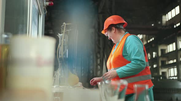 Mature Woman Working in Chemical Plant Focused Female Worker Wearing Hard Hat