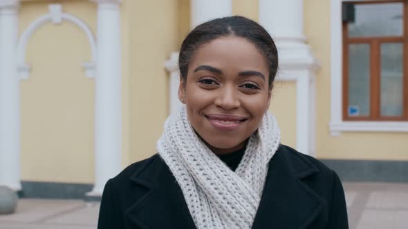 Cheerful African American Lady in Warm Coat and Scarf Smiling To Camera Outdoor Tracking Shot