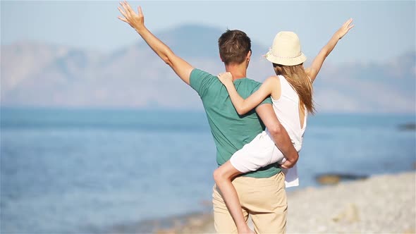 Little Girl and Happy Dad Having Fun During Beach Vacation