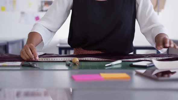 Mixed race woman taking measure in fashion office