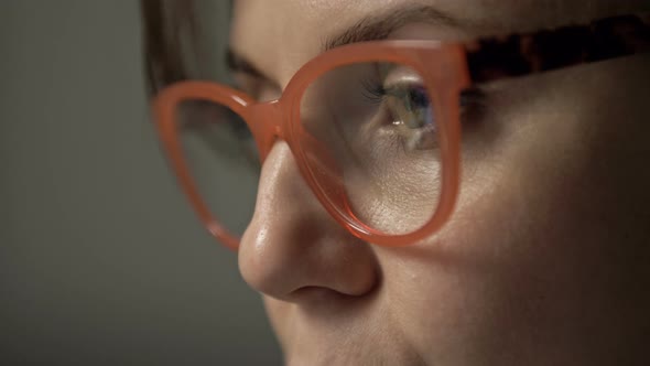 Close Up Portrait of Beautiful Serious Woman in Glasses Reflecting Computer Screen