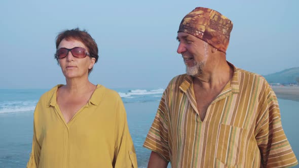 Senior Couple Walking on the Beach and Talking Steadicam Shot