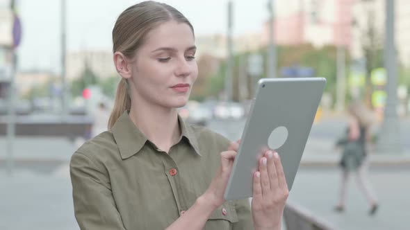 Woman using Digital Tablet Outdoor