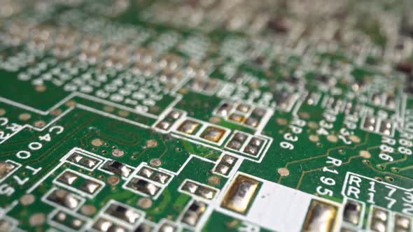 Extreme Closeup of Green Printed Circuit Board Electronics Shot with Dolly