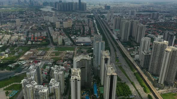 Camera tilts up from luxury high rise buildings and freeway to reveal epic city skyline and river la