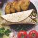 Traditional Turkish Doner Kebab in a Wrap Served with Fresh Ingredients and Deep Fried Dumplings - VideoHive Item for Sale