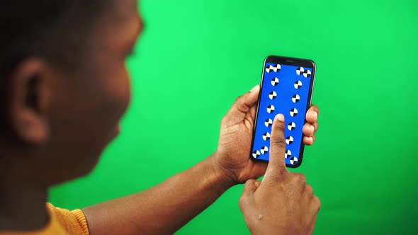 Closeup View of Smartphone in Black Man Hand with Tracking Markers on Display Who is Swiping Up