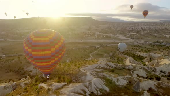 Aerial Hot Air Balloons Flying Over Hoodoos Fairy Chimneys in Cappadocia Turkey at Sunrise Morning