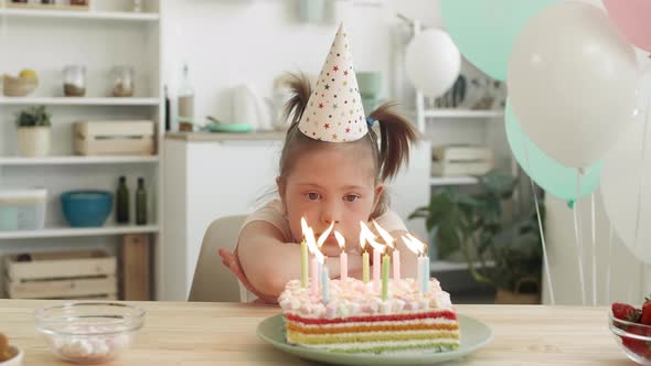 Sad Girl with Down Syndrome Having Birthday Party