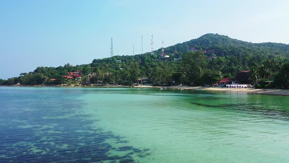 tropical island with jungle, white sand beach and crystal clear turquoise water. Aerial