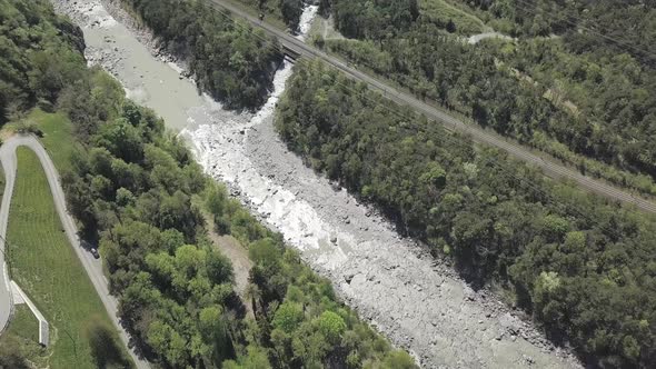 Aerial drone shot overlooking the Rhone river over flowing through Switzerland.