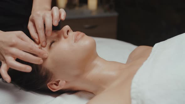 Caucasian Woman Receiving Facial Massage in Spa Skin Care Face Treatment Rejuvenation Procedure