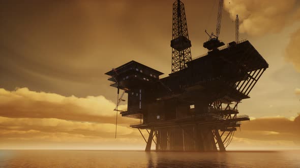Offshore Jack Up Rig in The Middle of The Sea at Sunset Time alt