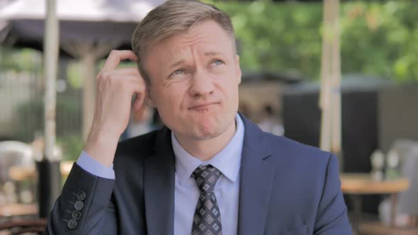 Outdoor Portrait of Pensive Businessman Thinking New Plan