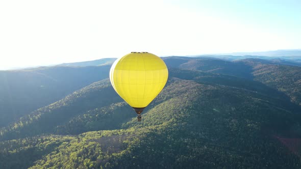 A Balloon Flies Over the Mountains