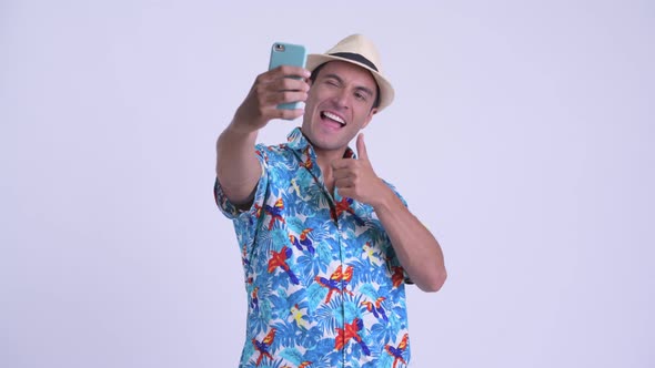 Young Happy Hispanic Tourist Man Taking Selfie