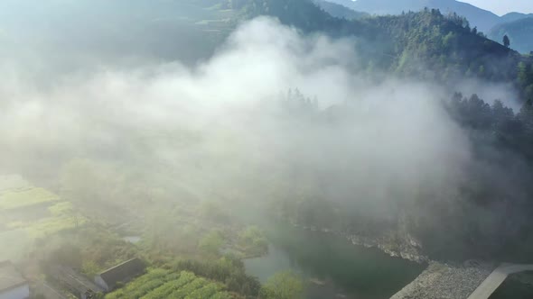 Aerial Photography Of A Small Village Terraced River Seen Through The Clouds