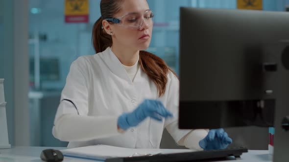 Science Engineer Working on Computer and Taking Notes