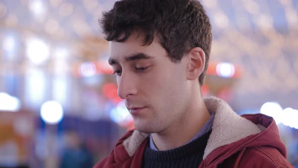 Christmas time - young depressed man raising his head and looking at camera