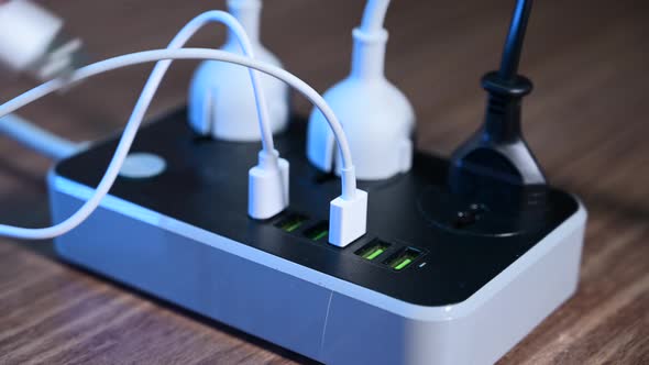 Closeup of a Male Hand Unplugging Cables From the Power Outlet