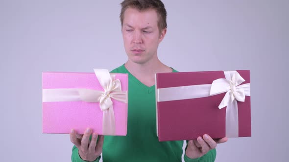Happy Young Handsome Man with Two Gift Boxes Ready for Valentine's Day