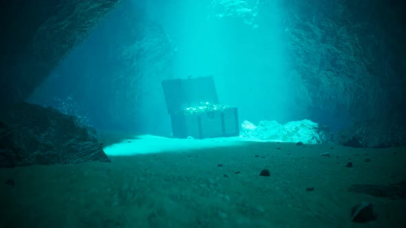 A treasure on the seabed in a secret underwater cave. Pirate chest in blue water