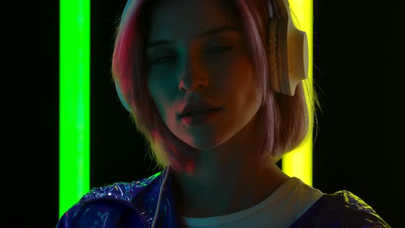 Portrait of a Young Stylish Woman Listening To Music and Dancing with Big White Headphones. Close Up