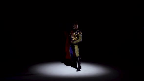 Torero in Blue and Gold Suit or Typical Spanish Bullfighter Isolated Spotlight on a Black Background