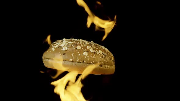 Close up of rotating burger bun in fire