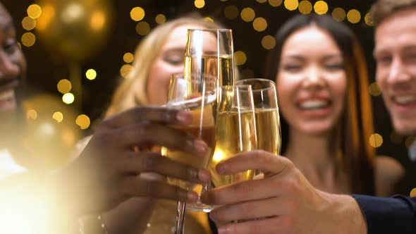 Company of Friends Clinking Champagne Glasses at New Year Party, Having Fun