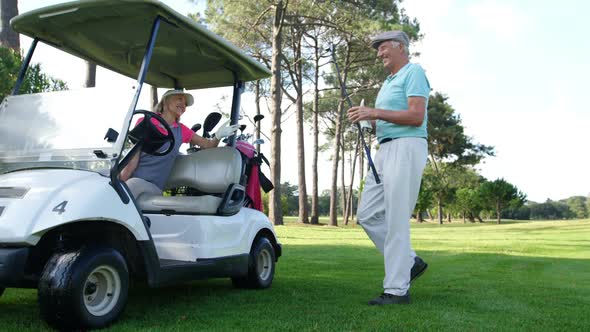 Male golf player interacting with woman