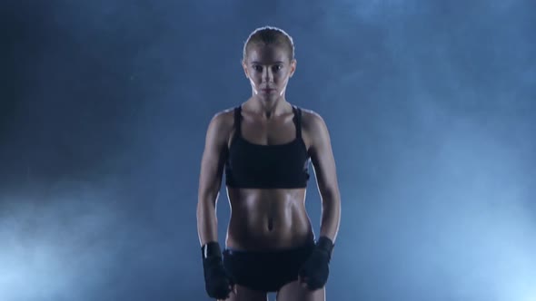 Sportswoman Boxer Warms Up the Muscles Before the Fight