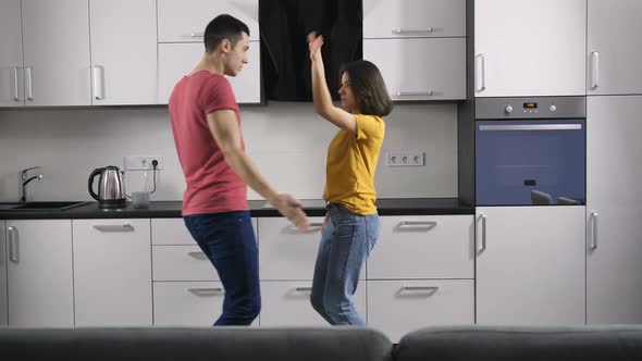 Young Married Couple Dancing in the Kitchen