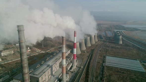 Aerial Drone View of Tall Chimney Pipes with Grey Smoke From Coal Power Plant