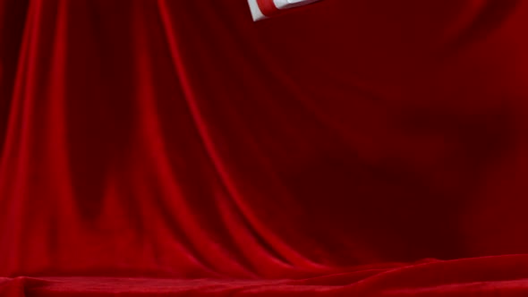 Present falls onto red fabric, Slow Motion