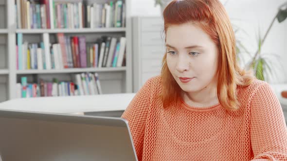 Young Woman Working on Her Laptop at the Library